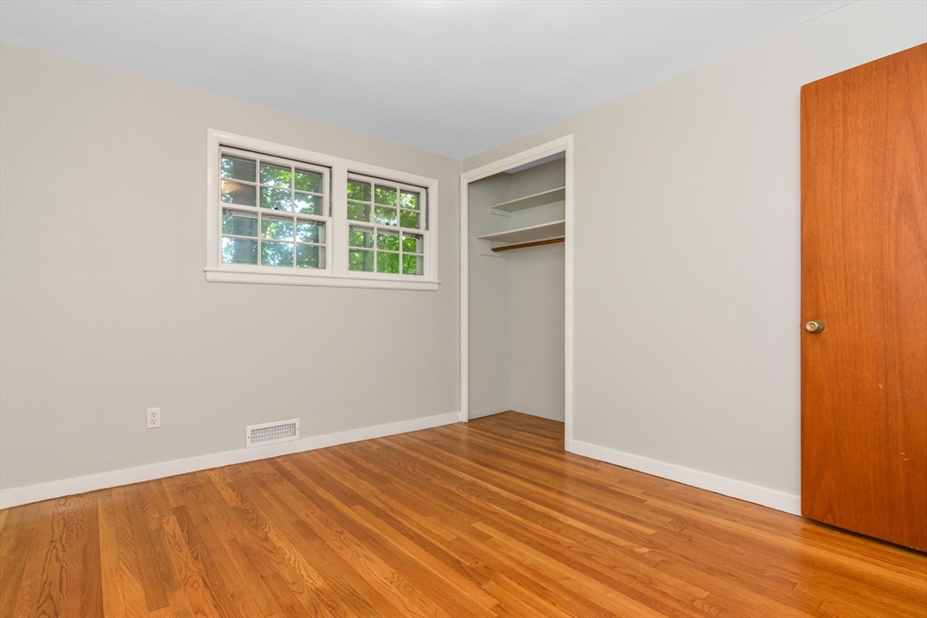 39 Beechmont Street Worcester, MA 01609 - Photo 14 of 42 an empty room with wooden floor and windows