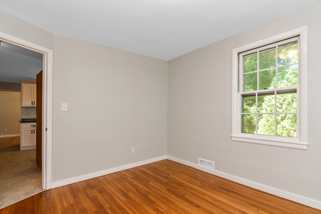 39 Beechmont Street Worcester, MA 01609 - Photo 15 of 42 a view of an empty room with wooden floor and a window
