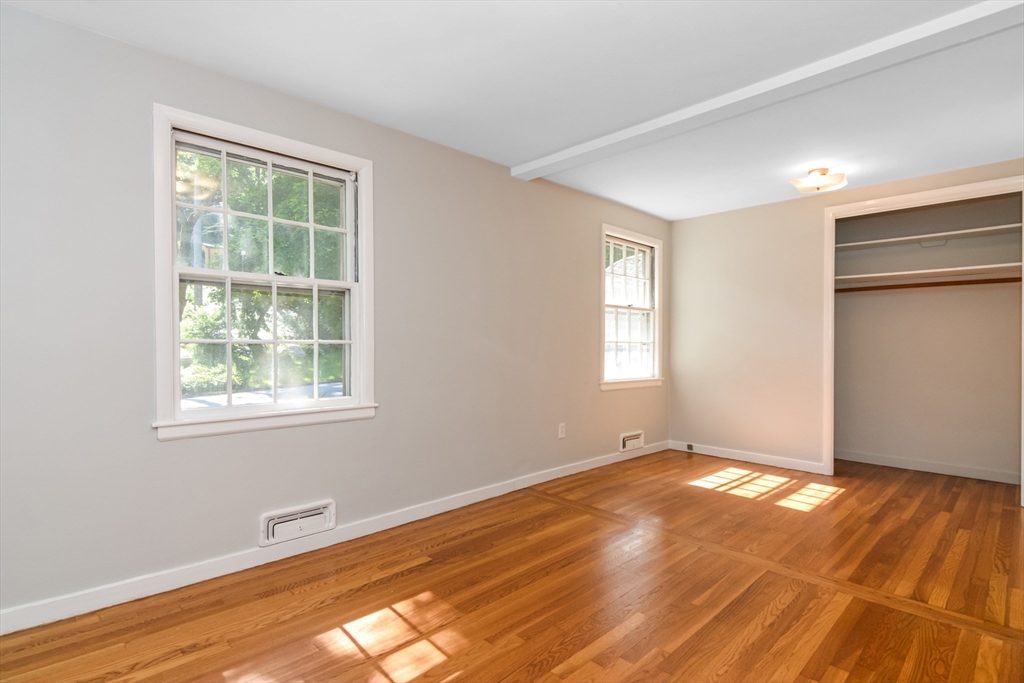 39 Beechmont Street Worcester, MA 01609 - Photo 19 of 42 a view of an empty room with wooden floor and a window