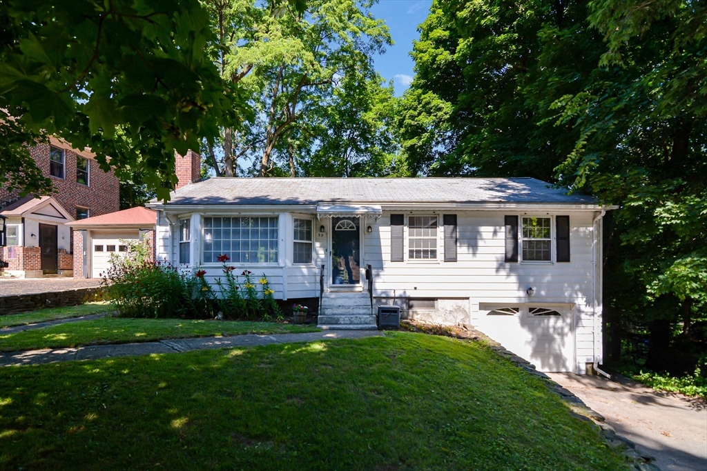 39 Beechmont Street Worcester, MA 01609 - Photo 30 of 42 a front view of a house with a yard table and chairs