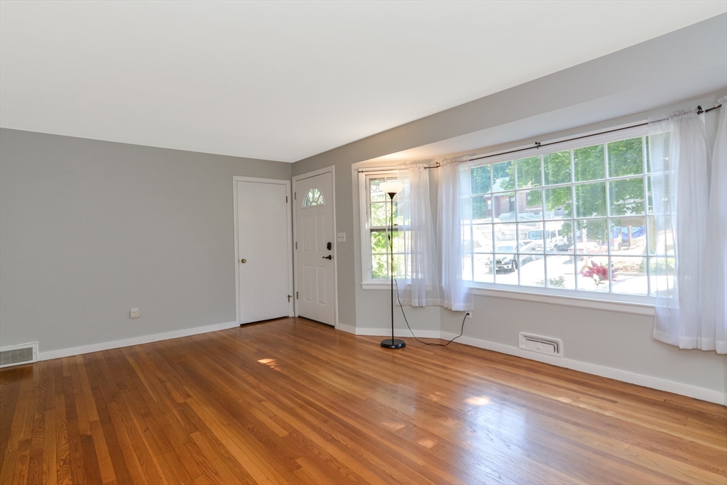 39 Beechmont Street Worcester, MA 01609 - Photo 3 of 42 a view of empty room with wooden floor and fan
