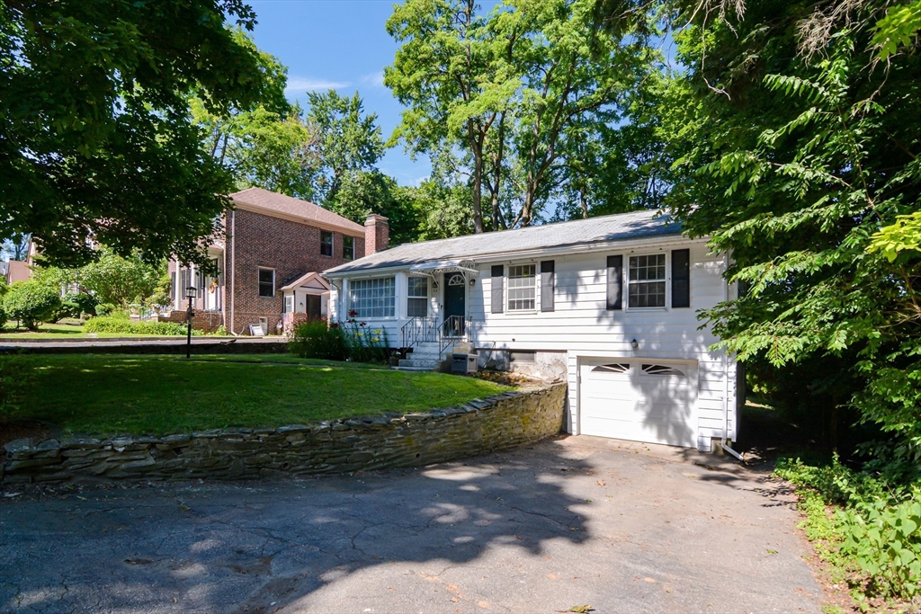 39 Beechmont Street Worcester, MA 01609 - Photo 31 of 42 a front view of a house with a yard and green space
