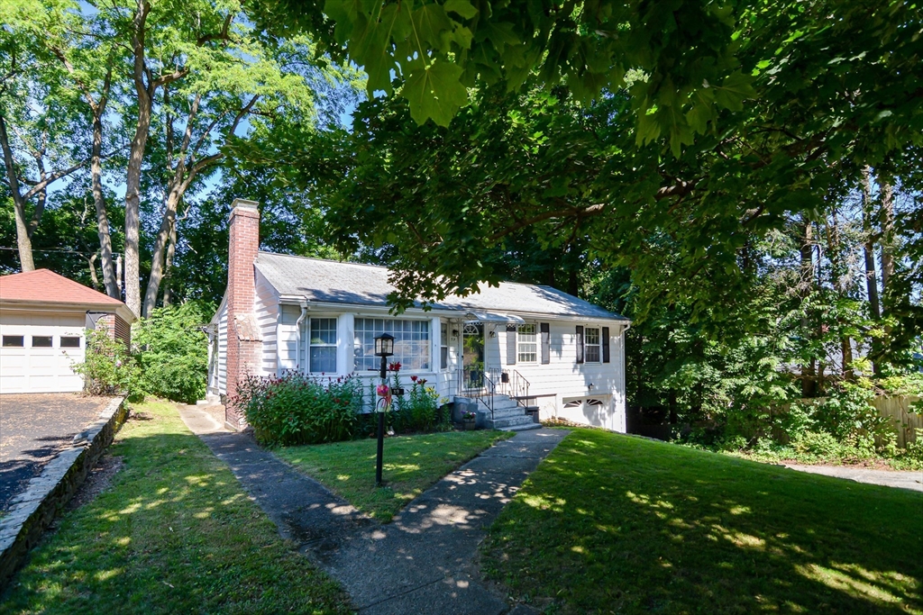 39 Beechmont Street Worcester, MA 01609 - Photo 32 of 42 a front view of a house with a garden and trees