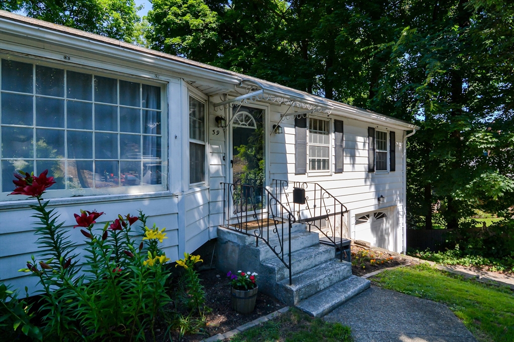 39 Beechmont Street Worcester, MA 01609 - Photo 33 of 42 a front view of a house with a garden