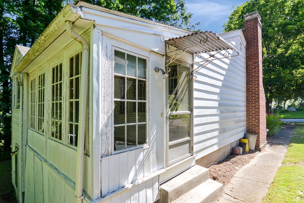 39 Beechmont Street Worcester, MA 01609 - Photo 34 of 42 a view of a house with a large window and wooden fence