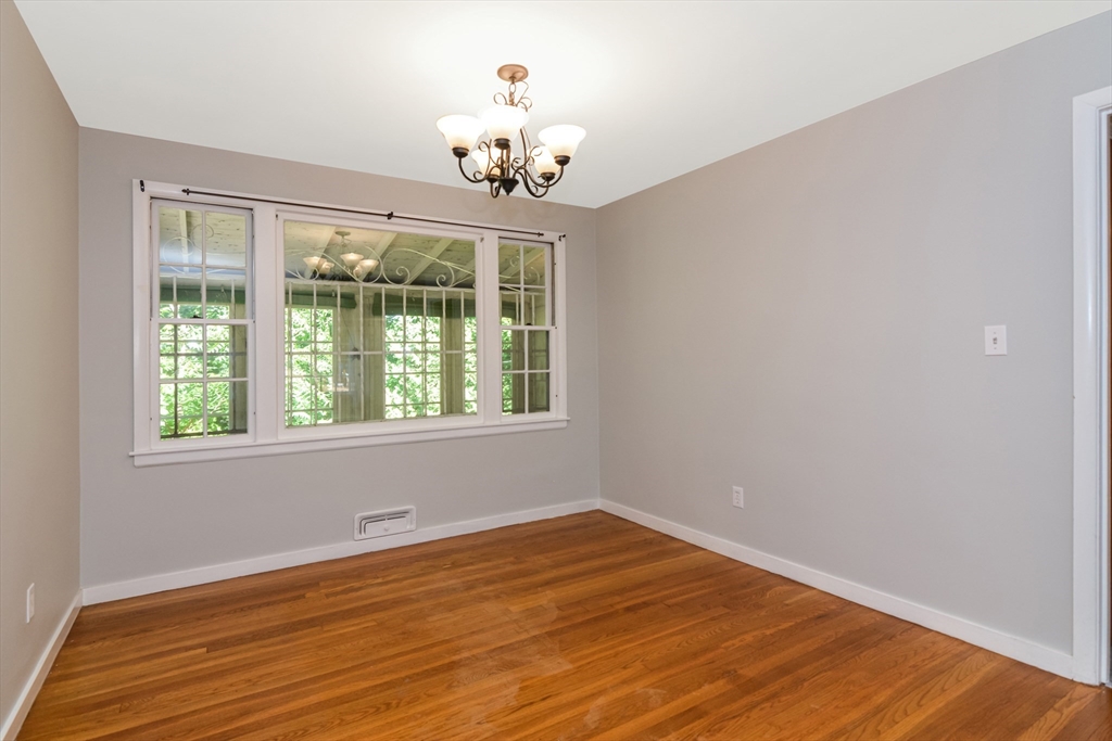 39 Beechmont Street Worcester, MA 01609 - Photo 5 of 42 a view of an empty room with wooden floor and a window