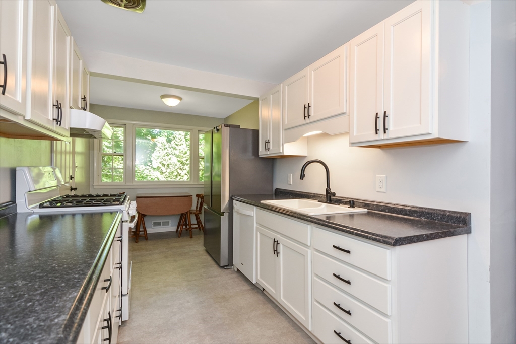 39 Beechmont Street Worcester, MA 01609 - Photo 10 of 42 a kitchen with a sink and a stove top oven