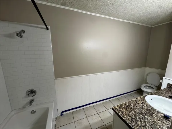 a bathroom with a bathtub and toilet