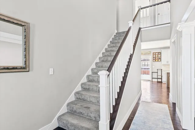 a view of a hallway with wooden floor and entryway