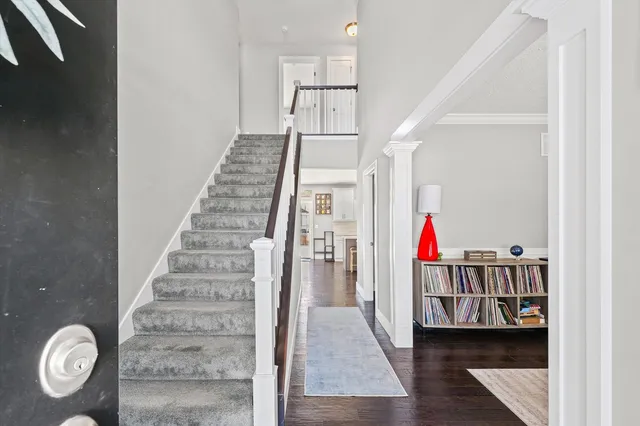 a view of entryway and hall with wooden floor