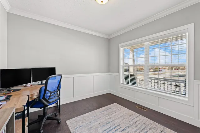a workspace with wooden floor and a window