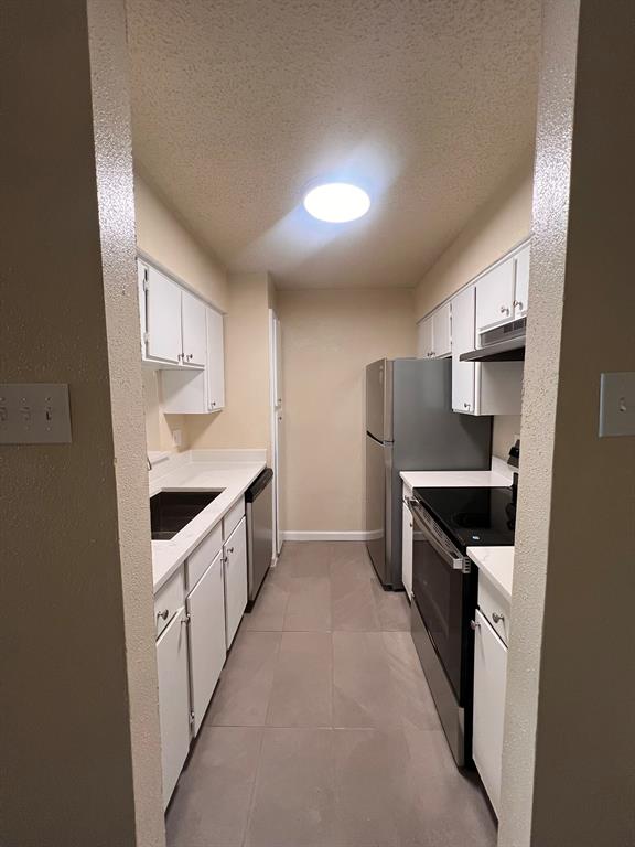 6050 Melody Lane, Unit 259 Dallas, TX 75231 - Photo 12 of 19 a kitchen with granite countertop a refrigerator and a stove