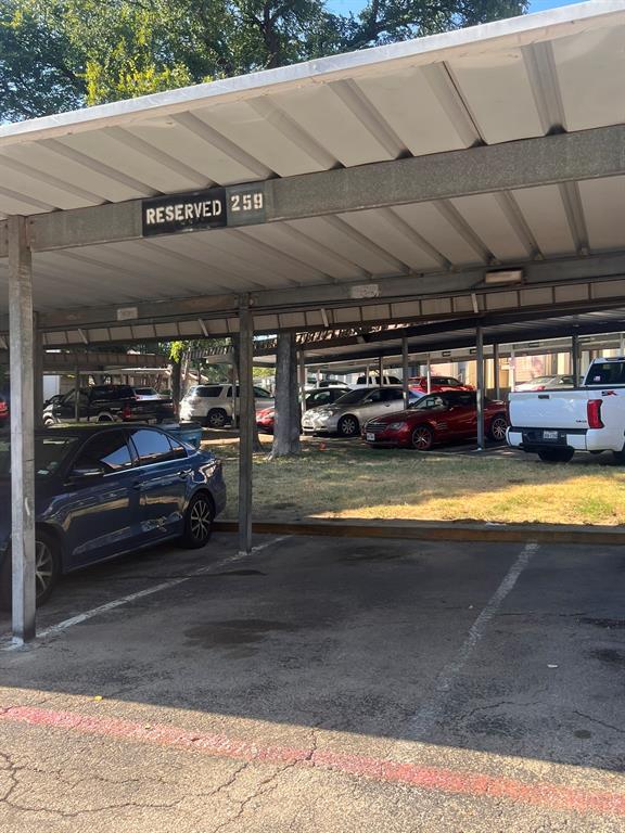 6050 Melody Lane, Unit 259 Dallas, TX 75231 - Photo 17 of 19 a view of a water heater and a car parked in a parking space