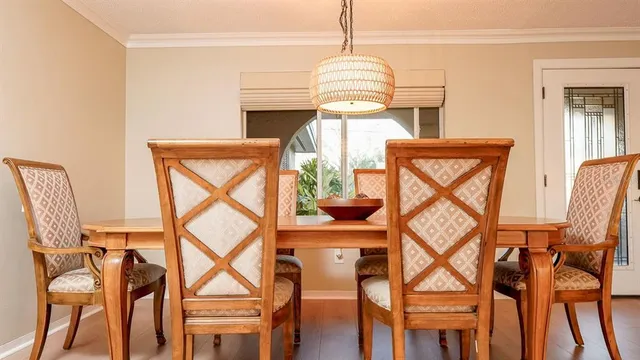 a view of a livingroom with furniture wooden floor windows and a chandelier