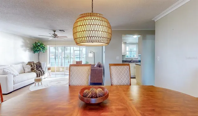 a dining room with furniture a chandelier and wooden floor