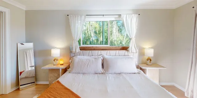 a bedroom with a bed and a lamp