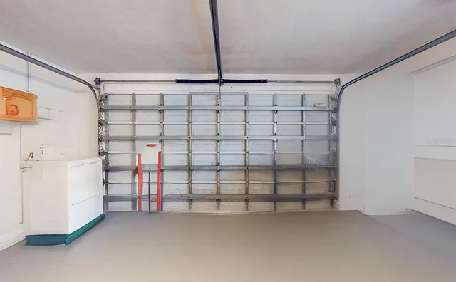 a view of a swimming pool with a lounge chair and palm trees
