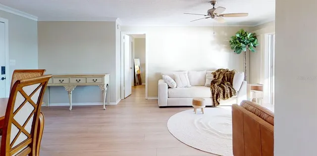 a view of a dining room with furniture and a chandelier