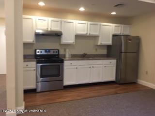 800 James Avenue, Unit 1104 Scranton, PA 18510 - Photo 3 of 35 a kitchen with stainless steel appliances white cabinets and white appliances