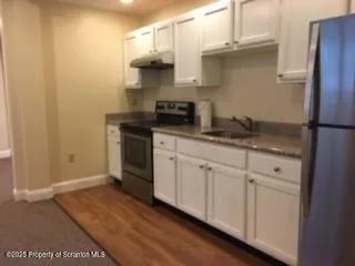 a kitchen with stainless steel appliances granite countertop a sink and a stove