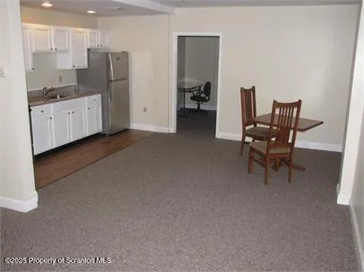 a kitchen with stainless steel appliances kitchen island granite countertop a refrigerator and a stove top oven