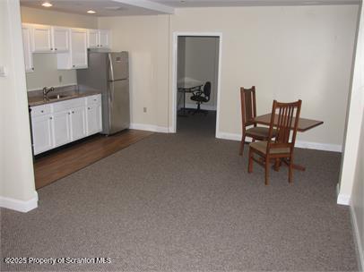 800 James Avenue, Unit 1104 Scranton, PA 18510 - Photo 7 of 35 a kitchen with stainless steel appliances kitchen island granite countertop a refrigerator and a stove top oven