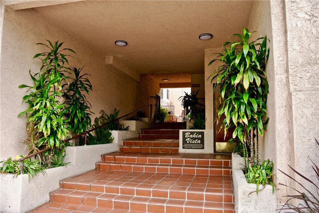 a front view of a house with plants