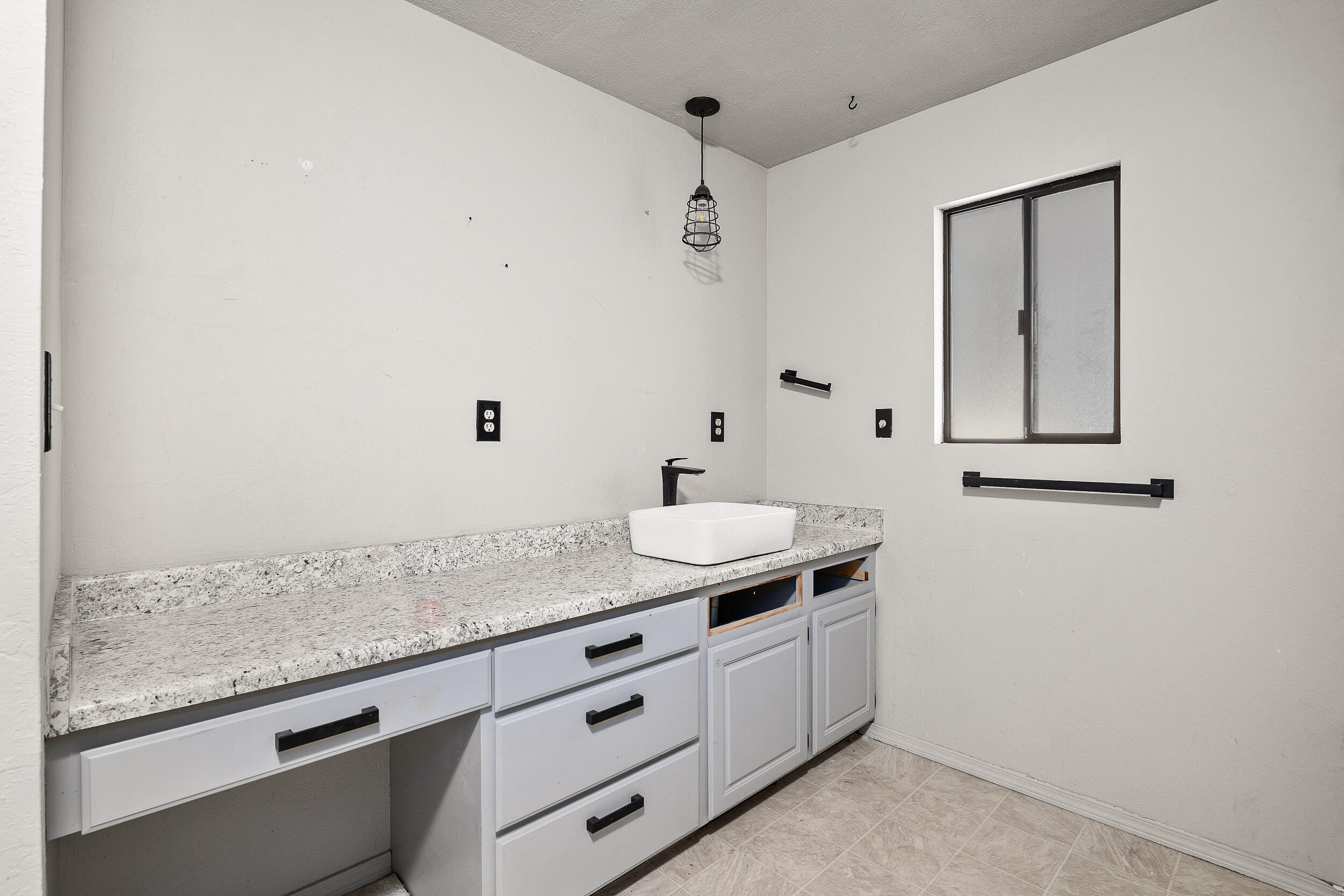 2781 Upper River Road Grants Pass, OR 97526 - Photo 29 of 53 a bathroom with a granite countertop sink and white cabinets