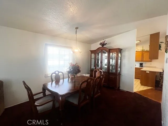 a view of a dining room with furniture and window