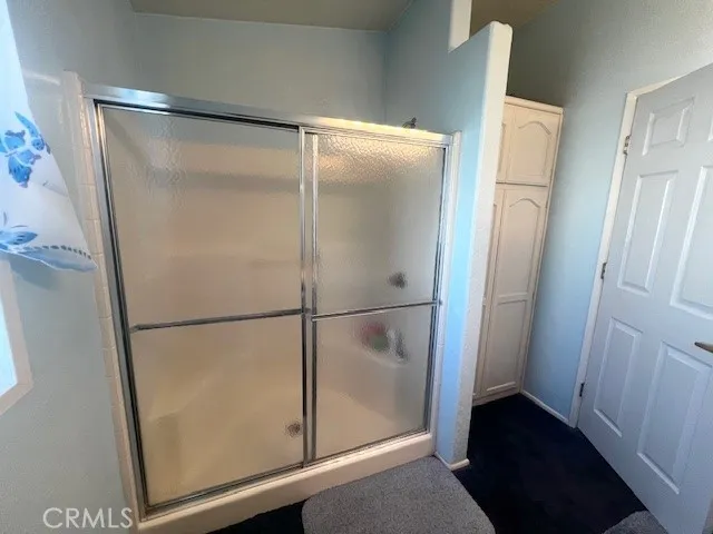 a bathroom with a glass shower door