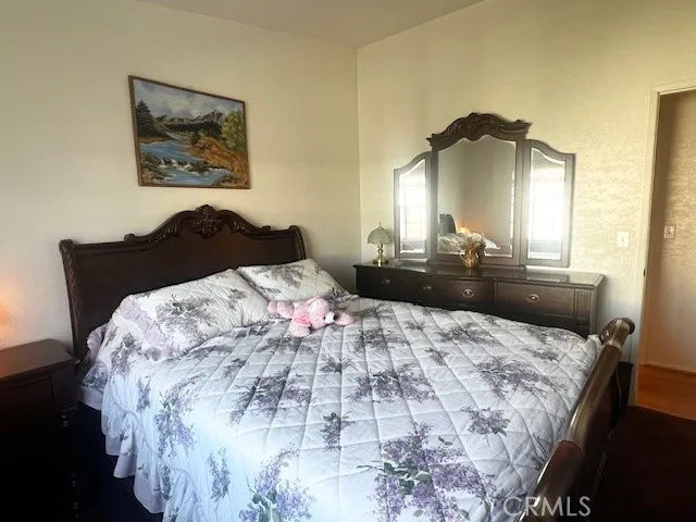 a bedroom with a bed and a dresser