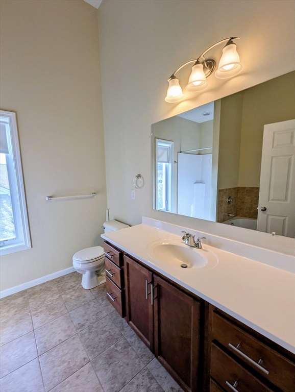 391 America Boulevard, Unit 391 Ashland, MA 01721 - Photo 11 of 22 a spacious bathroom with a toilet sink and mirror