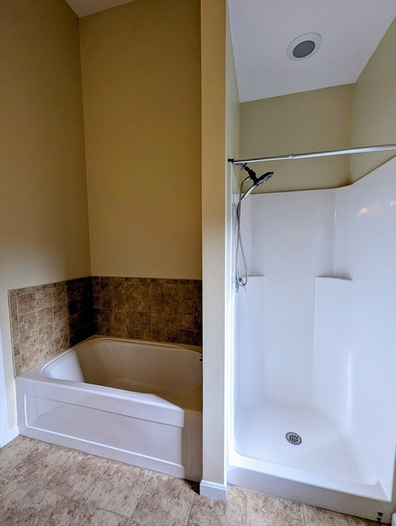 391 America Boulevard, Unit 391 Ashland, MA 01721 - Photo 12 of 22 a bathroom with a bath tub and shower