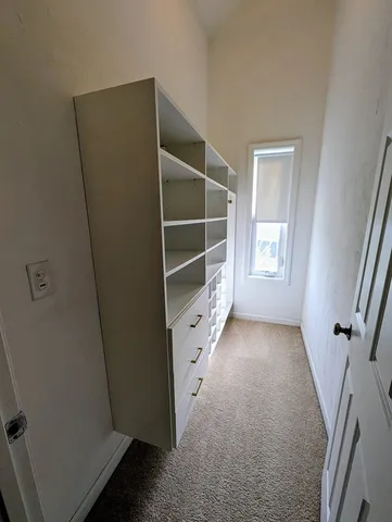 an empty room with windows and closet