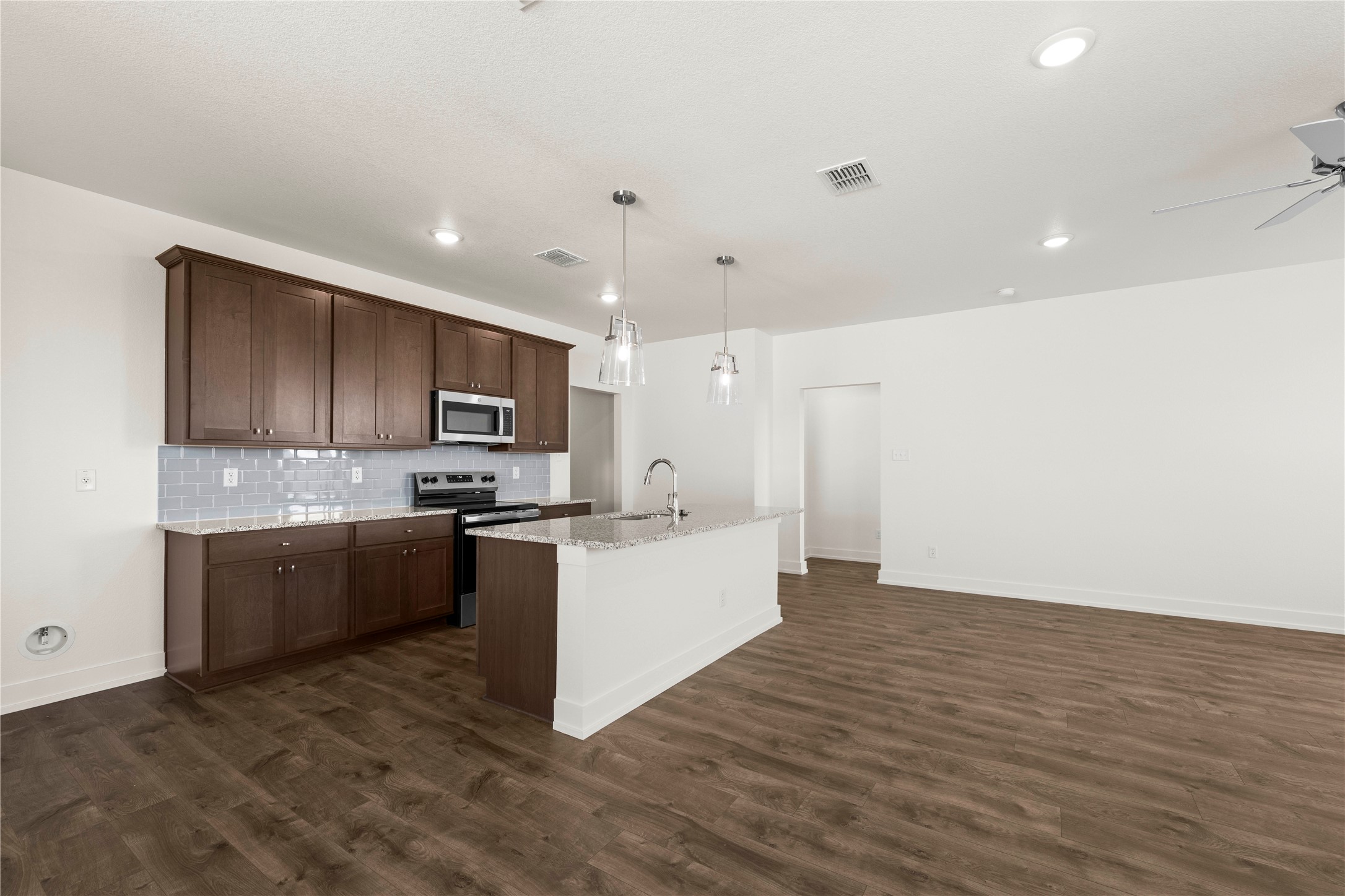 552 Gus Loop Georgetown, TX 78626 - Photo 9 of 23 a large kitchen with a counter top space a sink stainless steel appliances and cabinets