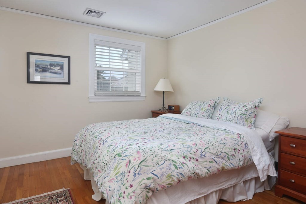 79 Evelyn Road Waban, MA 02468 - Photo 13 of 16 a bedroom with a bed and a lamp on dresser