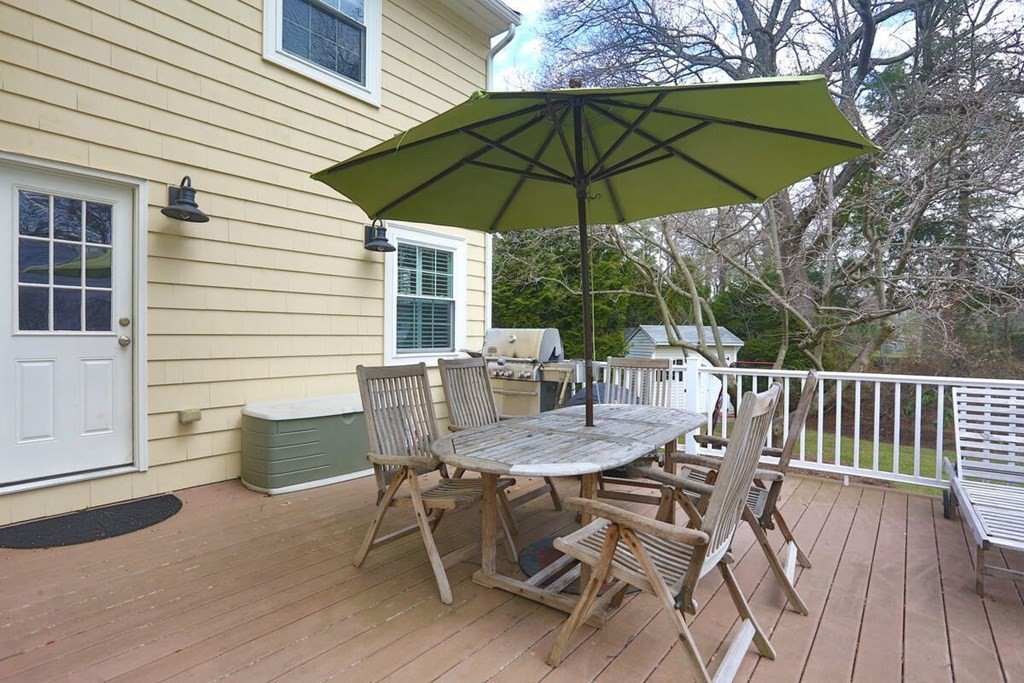 79 Evelyn Road Waban, MA 02468 - Photo 16 of 16 a view of a patio with a table and chairs under an umbrella
