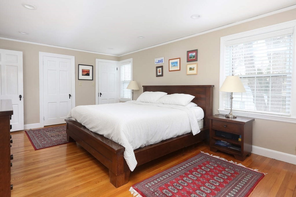 79 Evelyn Road Waban, MA 02468 - Photo 9 of 16 a bedroom with a bed lamp and a dresser next to a window