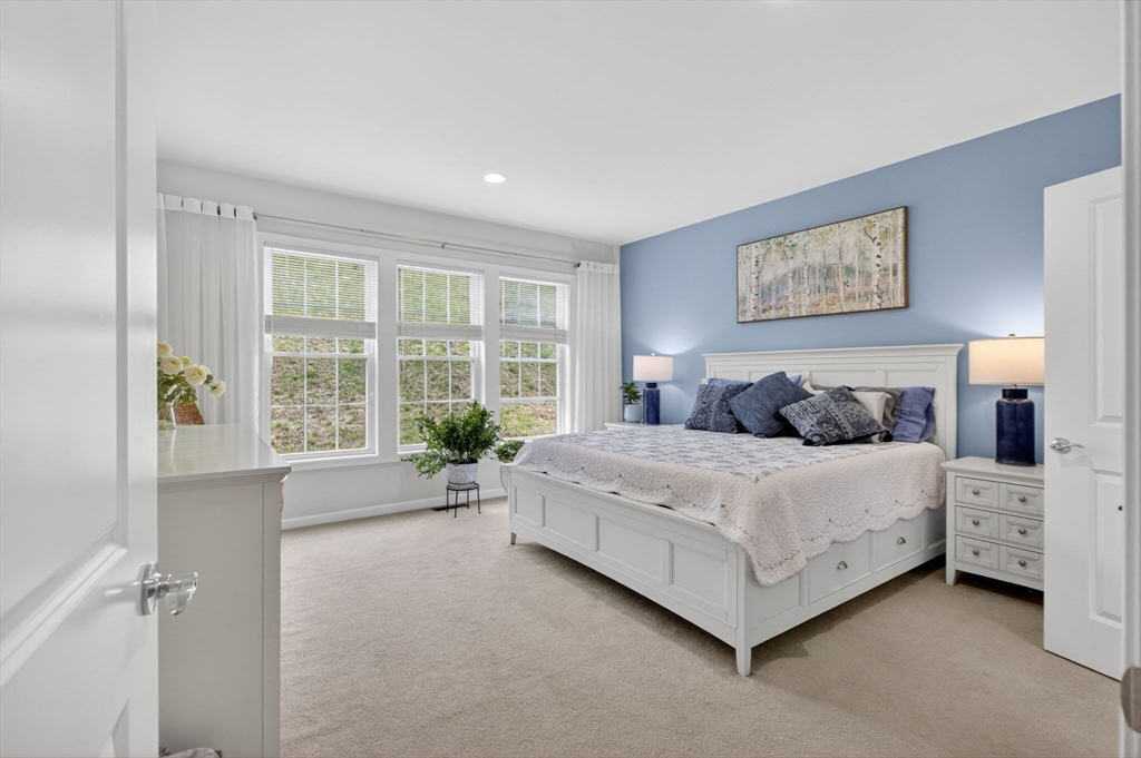 87 Shannon Way, Unit 86 Upton, MA 01568 - Photo 14 of 36 a spacious bedroom with a bed and a large window