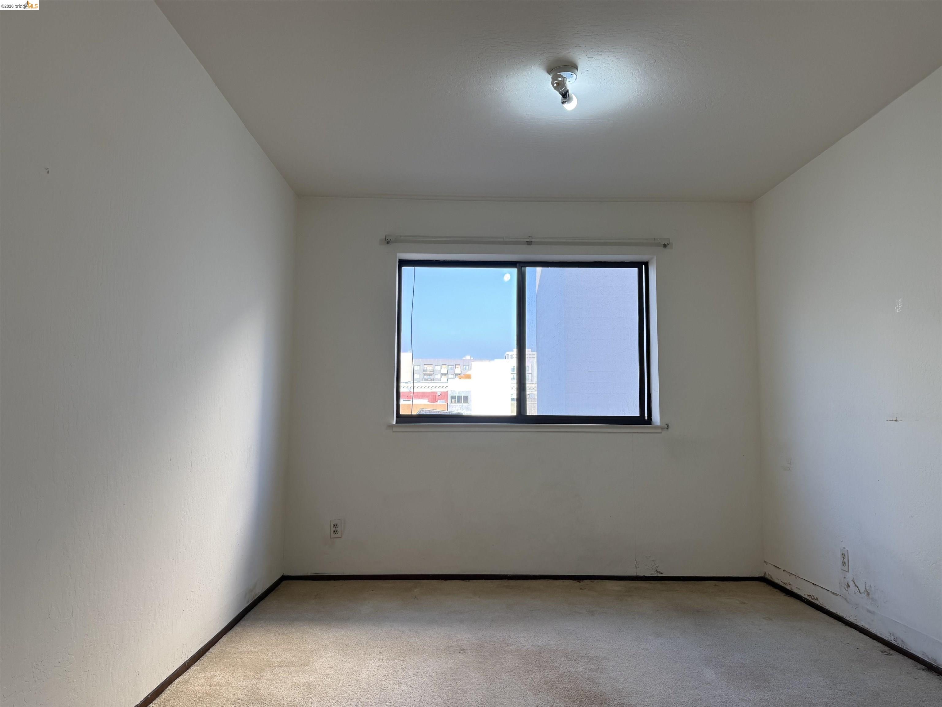 330 8th Street, Unit 3D Oakland, CA 94607 - Photo 11 of 13 Empty room featuring light carpet