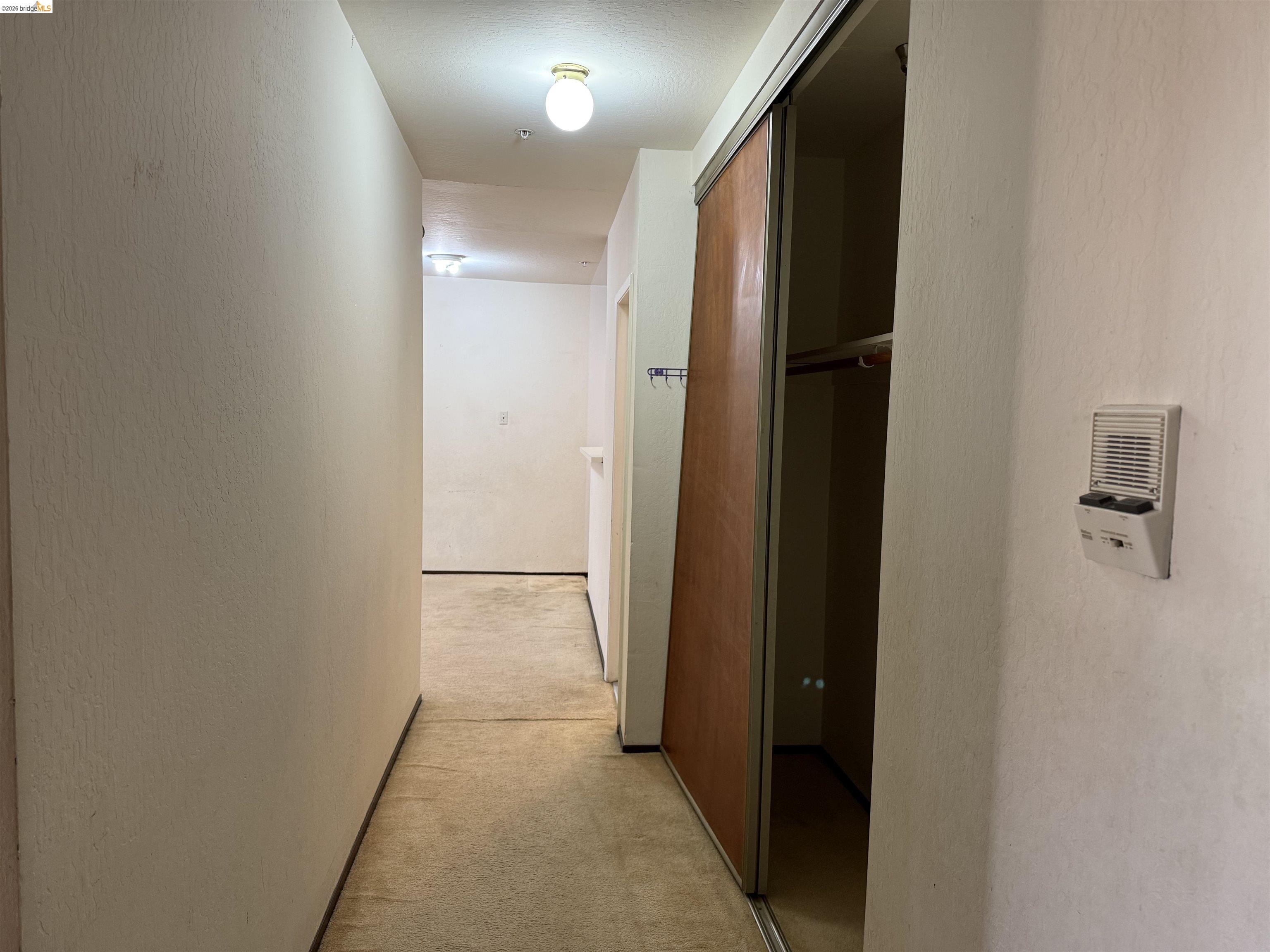 330 8th Street, Unit 3D Oakland, CA 94607 - Photo 2 of 13 Hall featuring a textured wall and light colored carpet