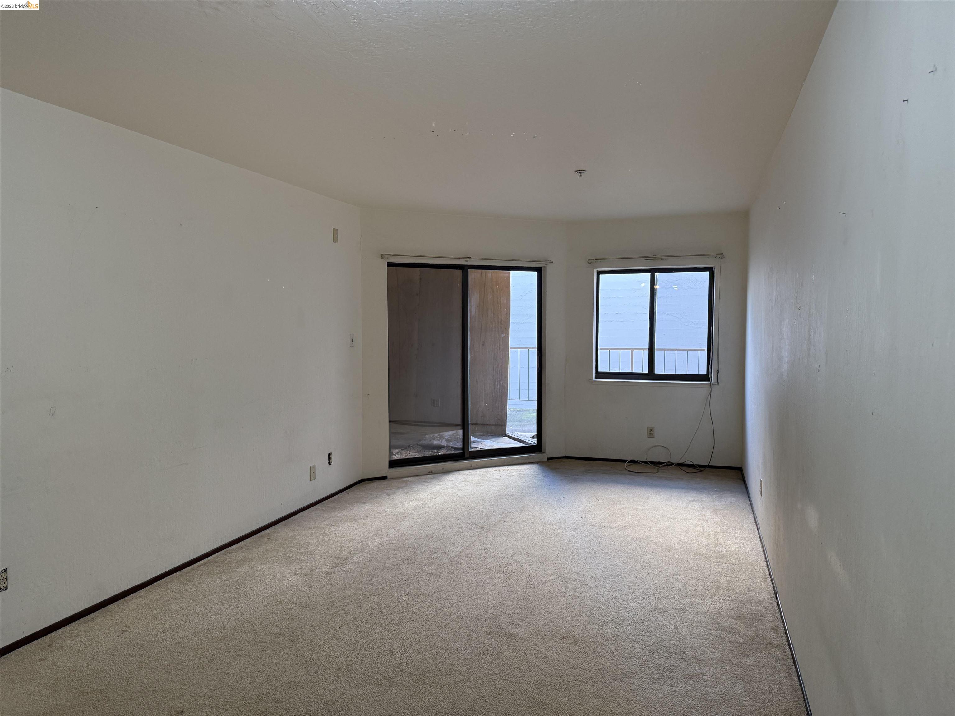 330 8th Street, Unit 3D Oakland, CA 94607 - Photo 5 of 13 Unfurnished room featuring light colored carpet