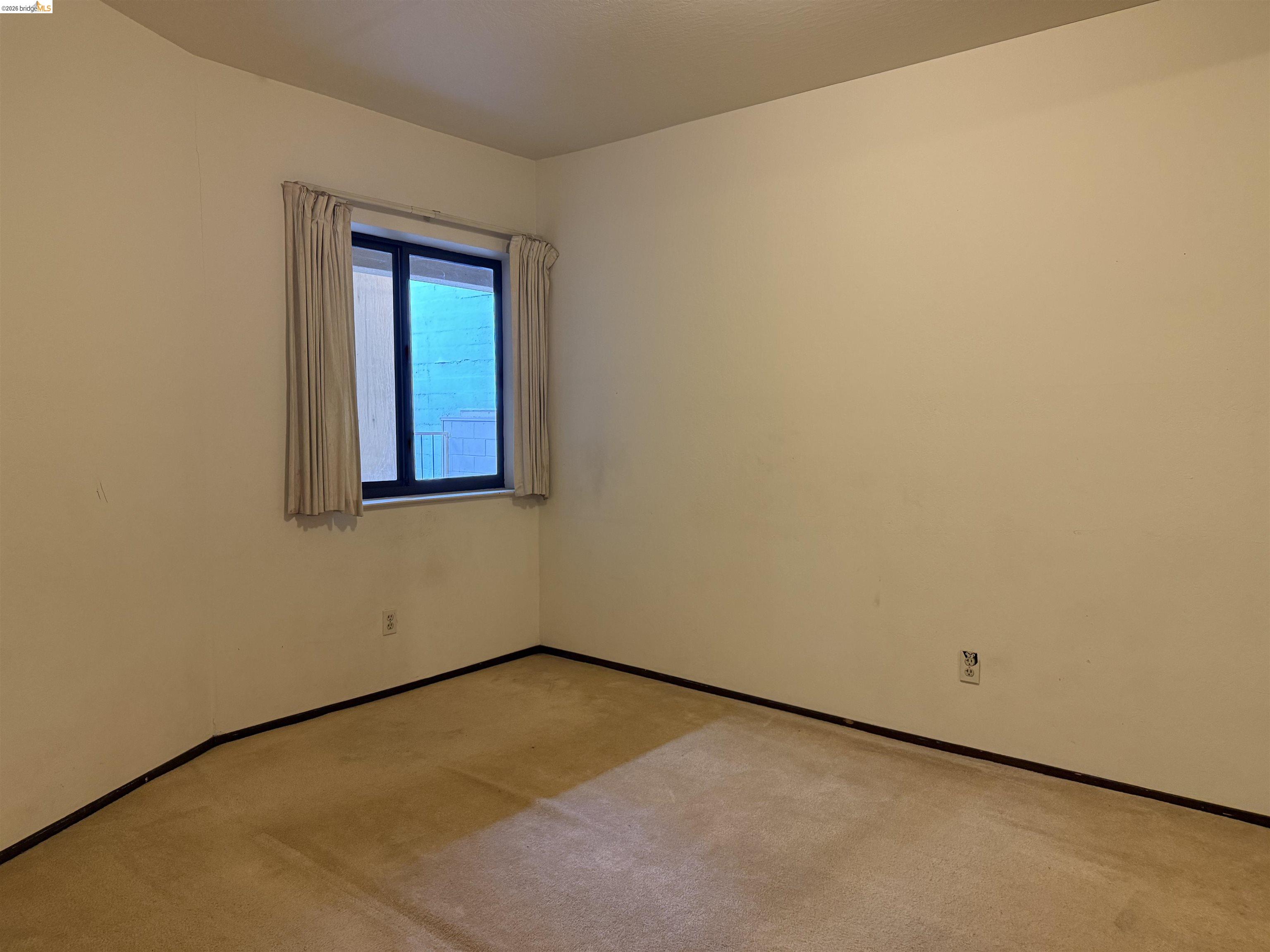 330 8th Street, Unit 3D Oakland, CA 94607 - Photo 8 of 13 Unfurnished room featuring light colored carpet and baseboards