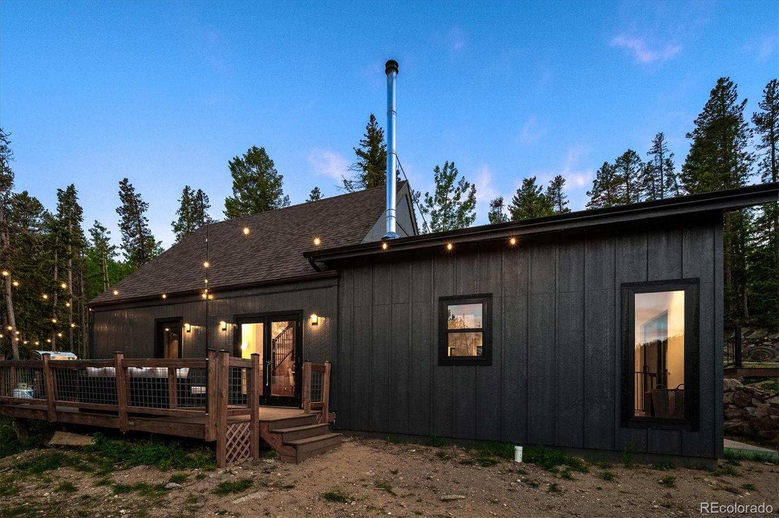 1633 Sinton Road Evergreen, CO 80439 - Photo 4 of 50 a front view of a house with a yard