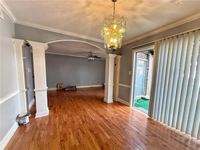 a view of a room with wooden floor and staircase