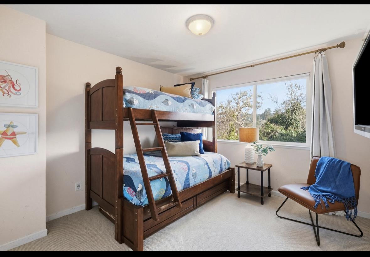 229 Rio Del Mar Boulevard Aptos, CA 95003 - Photo 10 of 27 a bedroom with furniture and a fireplace