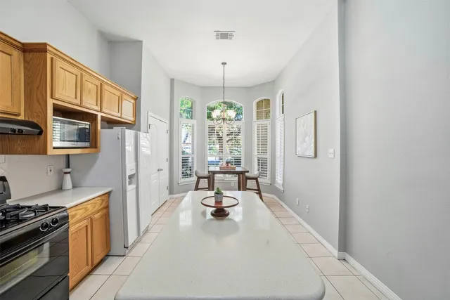 a large white kitchen with a large window