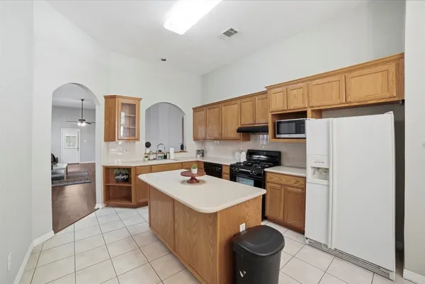 a kitchen with a sink appliances and cabinets