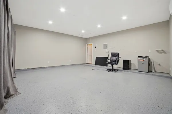 a view of a big room with windows and lounge chair