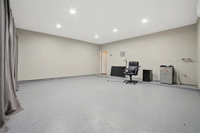 a view of a big room with windows and lounge chair